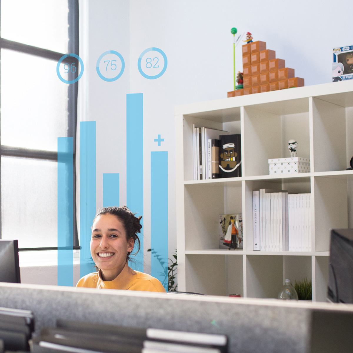 A woman in a yellow shirt smiling eagerly in an office, likely in anticipation of her new SEO training.